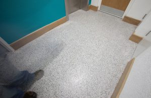What are the benefits of refurbishing social housing developments with resin floors?